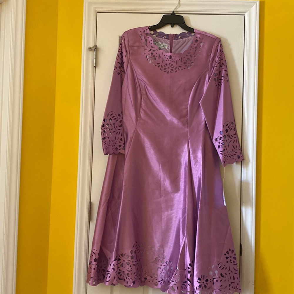 Woman’s dress size 16 with lace cut sleeves and front hem.